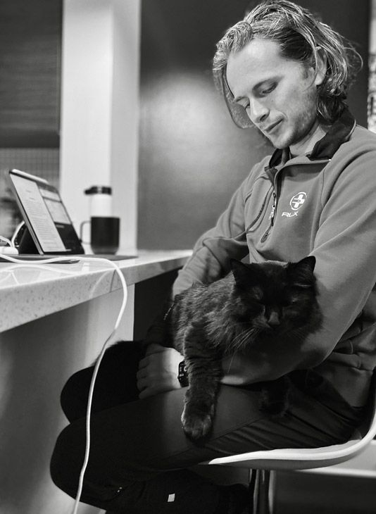 A man sitting with his cat